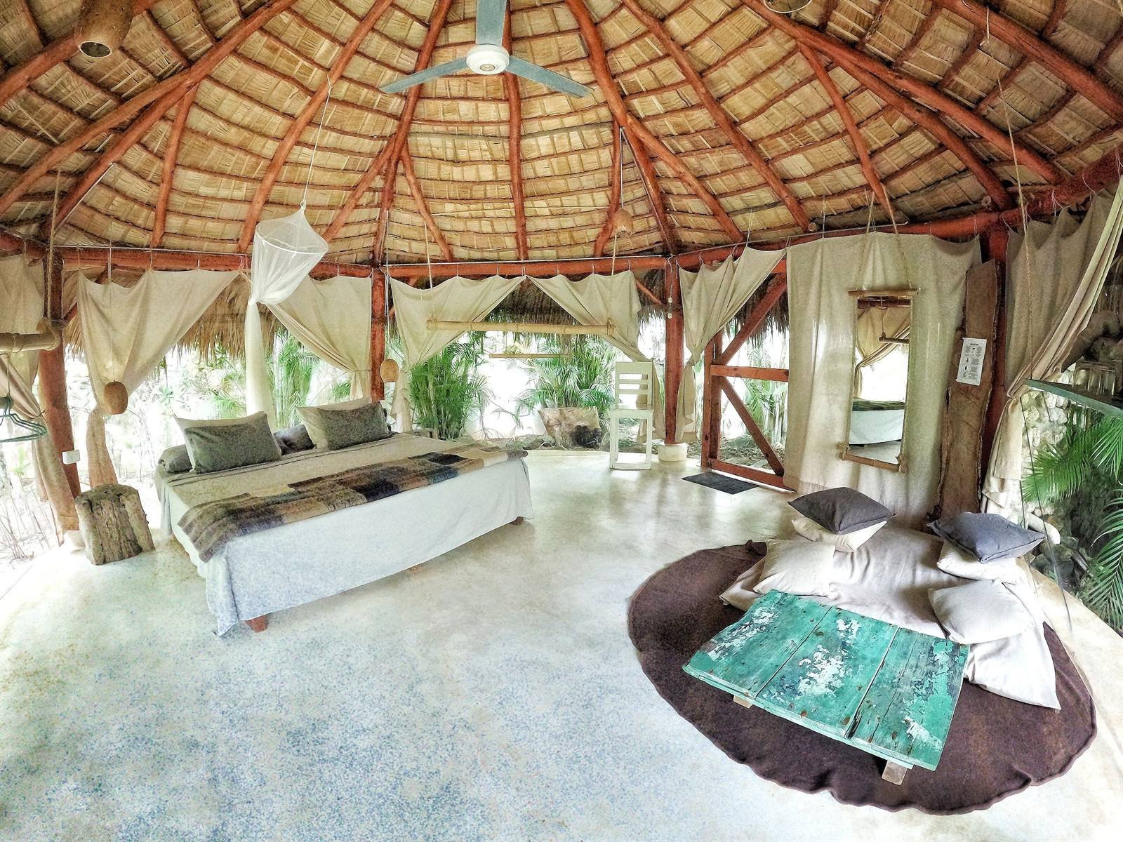 Casa Picaflor: spacious luxury tent room with a king bed, sofa and ceiling fan